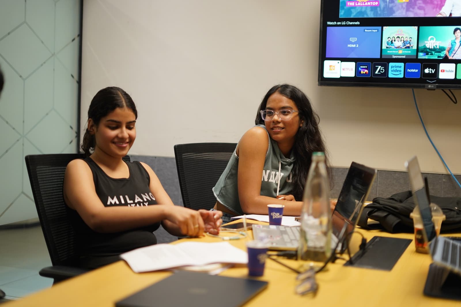 Two team members working together at a desk in the Divuzl office